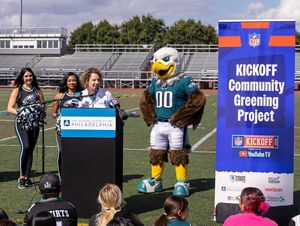 Lori Brennan, Executive Director of TNC Pennsylvania and Delaware, stands outdoors in front of the event podium to comment on the importance of this tree-planting initiative.