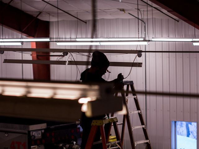 Electrician installs LED fixtures at the Cornish Fire Department.
