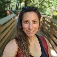 Person standing in forest.