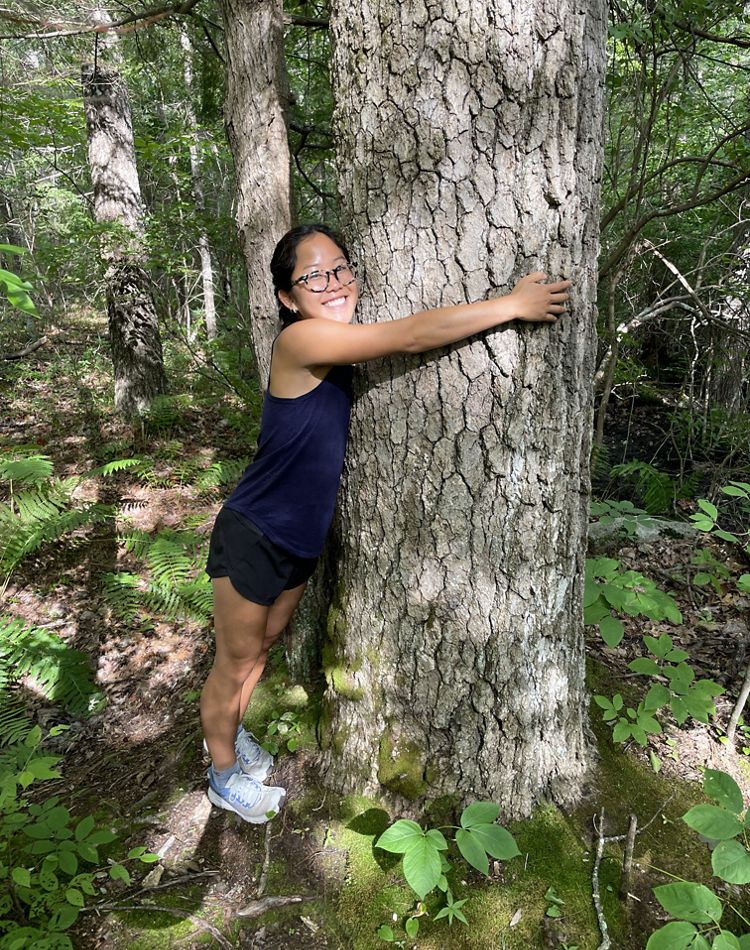 Li Platz hugging a large black gum tree.