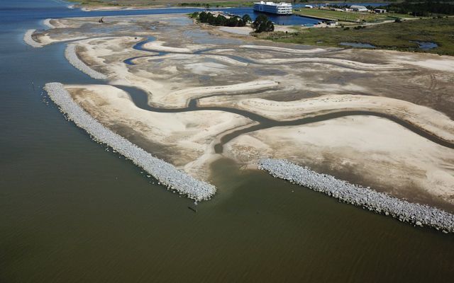 Coastal landscape with reinforced seawall made of rocks.