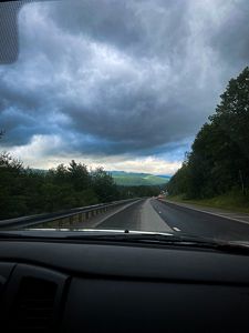 View of a road from the passenger seat of a vehicle.