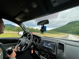 View taken from inside a car of a woman driving.