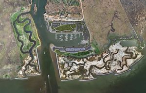 A drawing features an aerial view of a town located along the water.