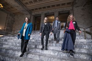 Four people coming down the steps. 