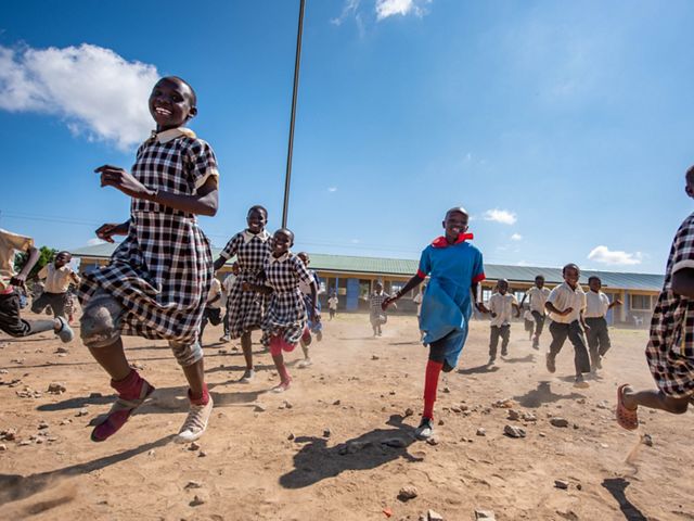 Students run into the schoolyard at Amani School, Lakipia County, Kenya.