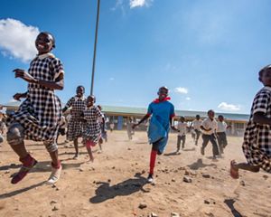 children running through a schoolyard.