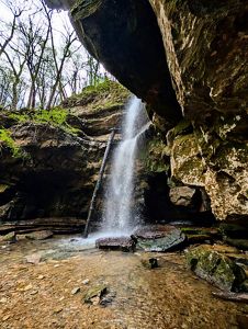 A waterfall between big boulders.
