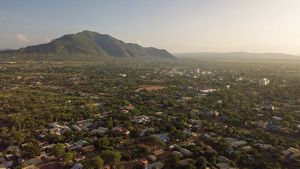 An aerial view of a town with mountains in the background.