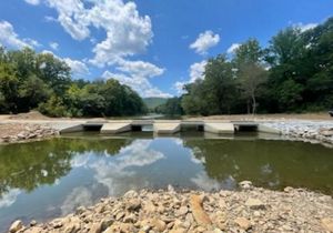 A new bridge with large openings that allow water to easily flow under the bridge. 