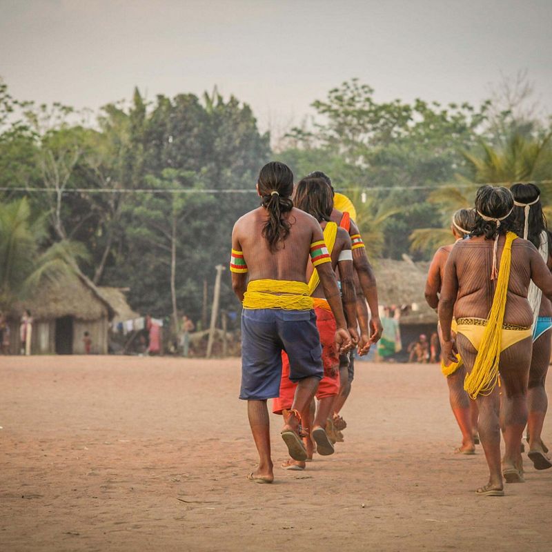 Several people walk through the Kokraimoro community in Sao Felix do Xingu, Brazilian Amazon.