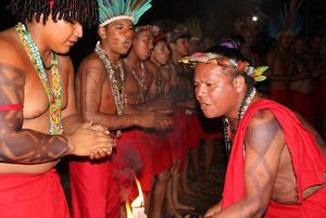 Group of young men with red traditional clothes in a ceremony. 