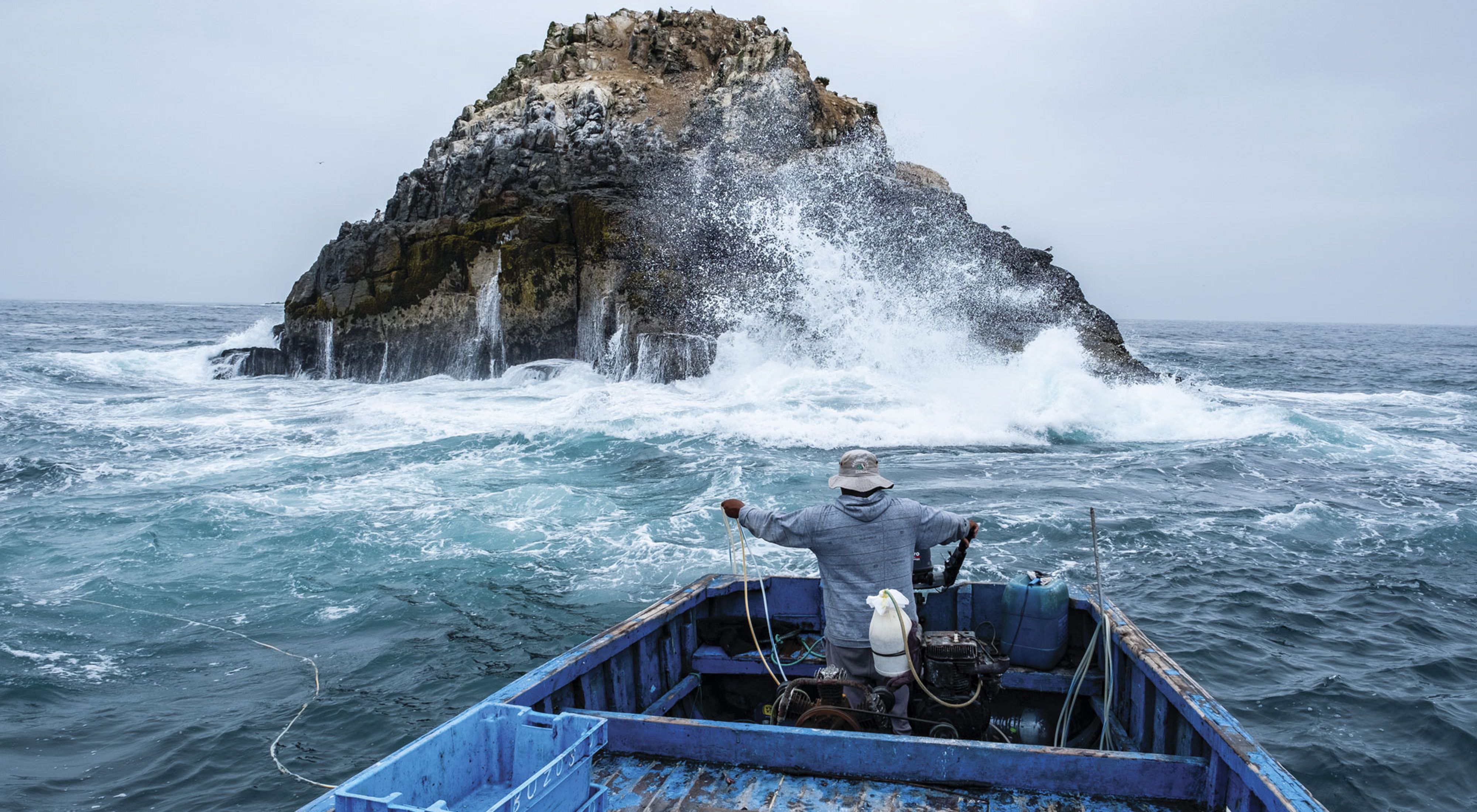 Frente a la costa de Ancón, el pescador
José Martín Garrido sostiene líneas de aire para su buceadorque está en las profundidades pescando especies a mano