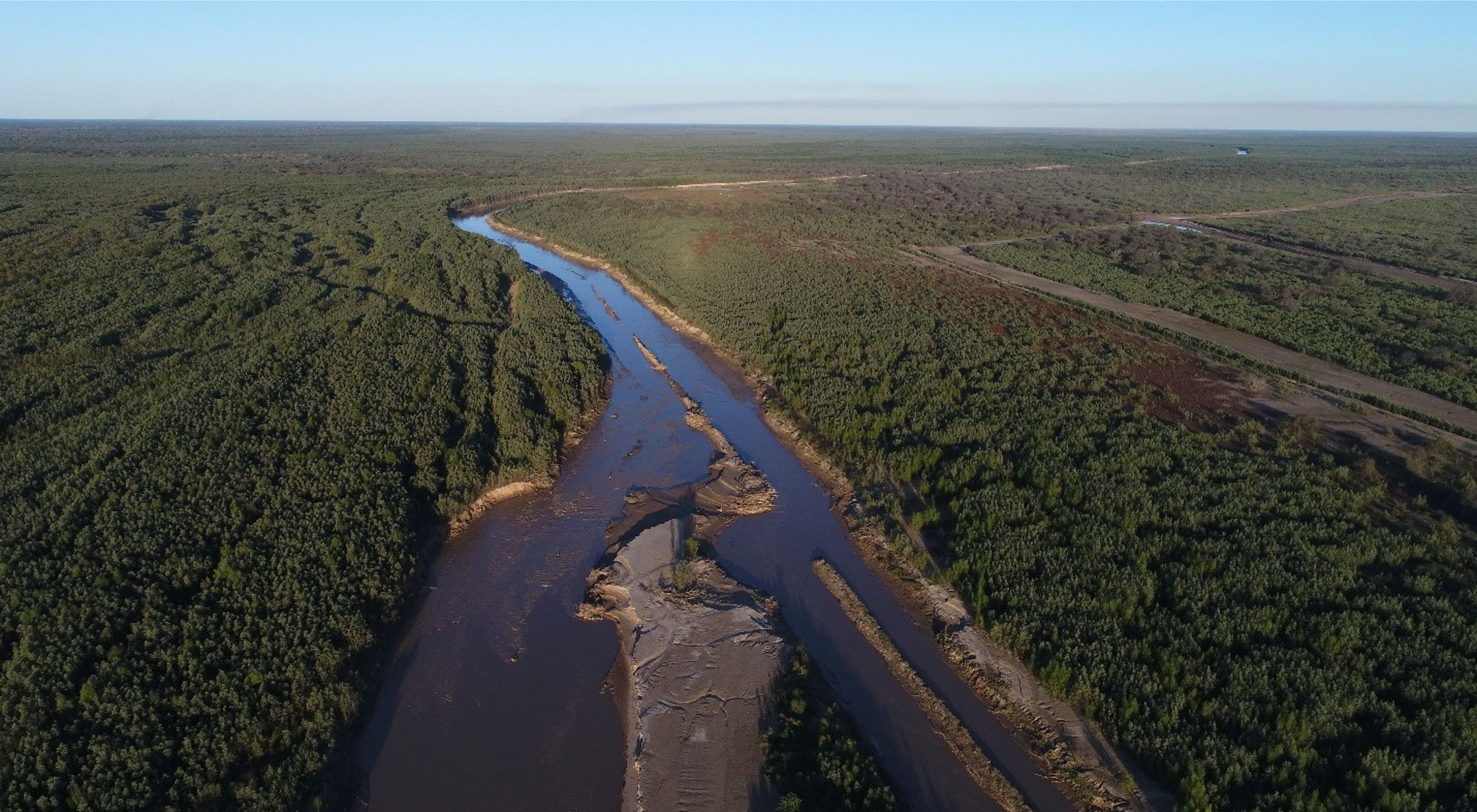 a sweeping view of a river flowing through the gran chaco landscape