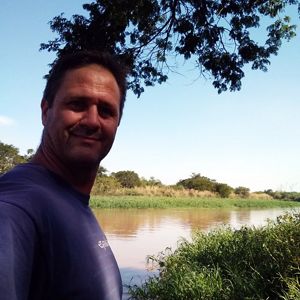 Photo of Gustavo Marino in the shade of trees.