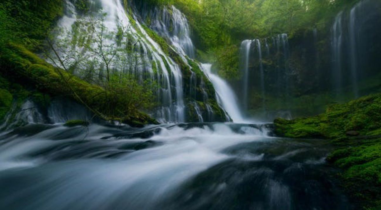 Fresh, clear water splashes against a white backdrop.