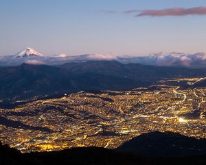 Quito at night with the Chimborazo snow peak in the background
