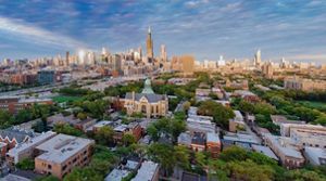 An aerial photograph of residential neighborhoods with the Chicago skyline in the background. 
