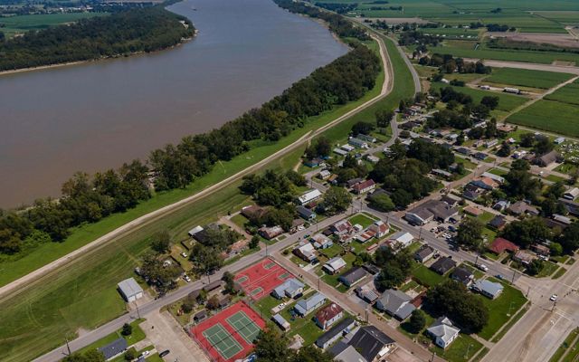 Aerial view of a small town along the edge of the Mississippi River.