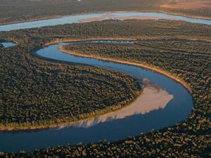 A river meanders through a forested landscape.