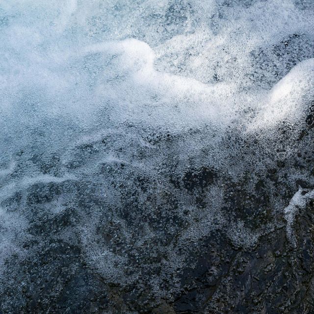 Fast moving water splashes in whitewater rapids.