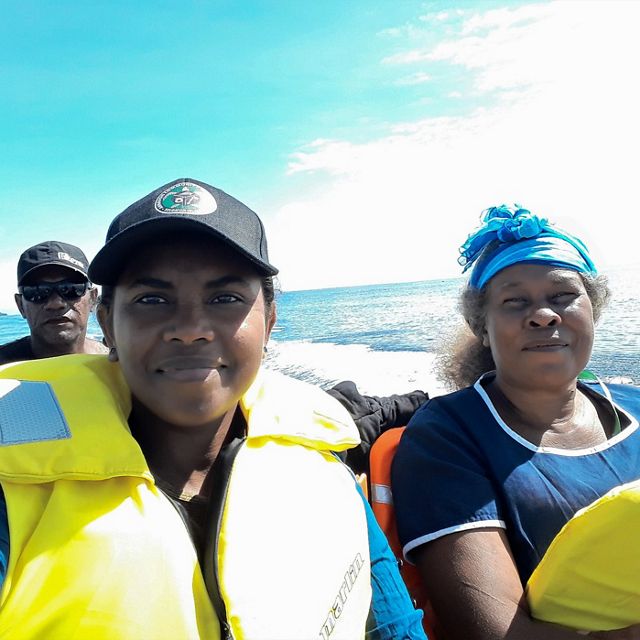 Madlyn Ero, in a hat and life vest, and the Mothers Union Leader on a boat trip in Isabel Province, March 2020.