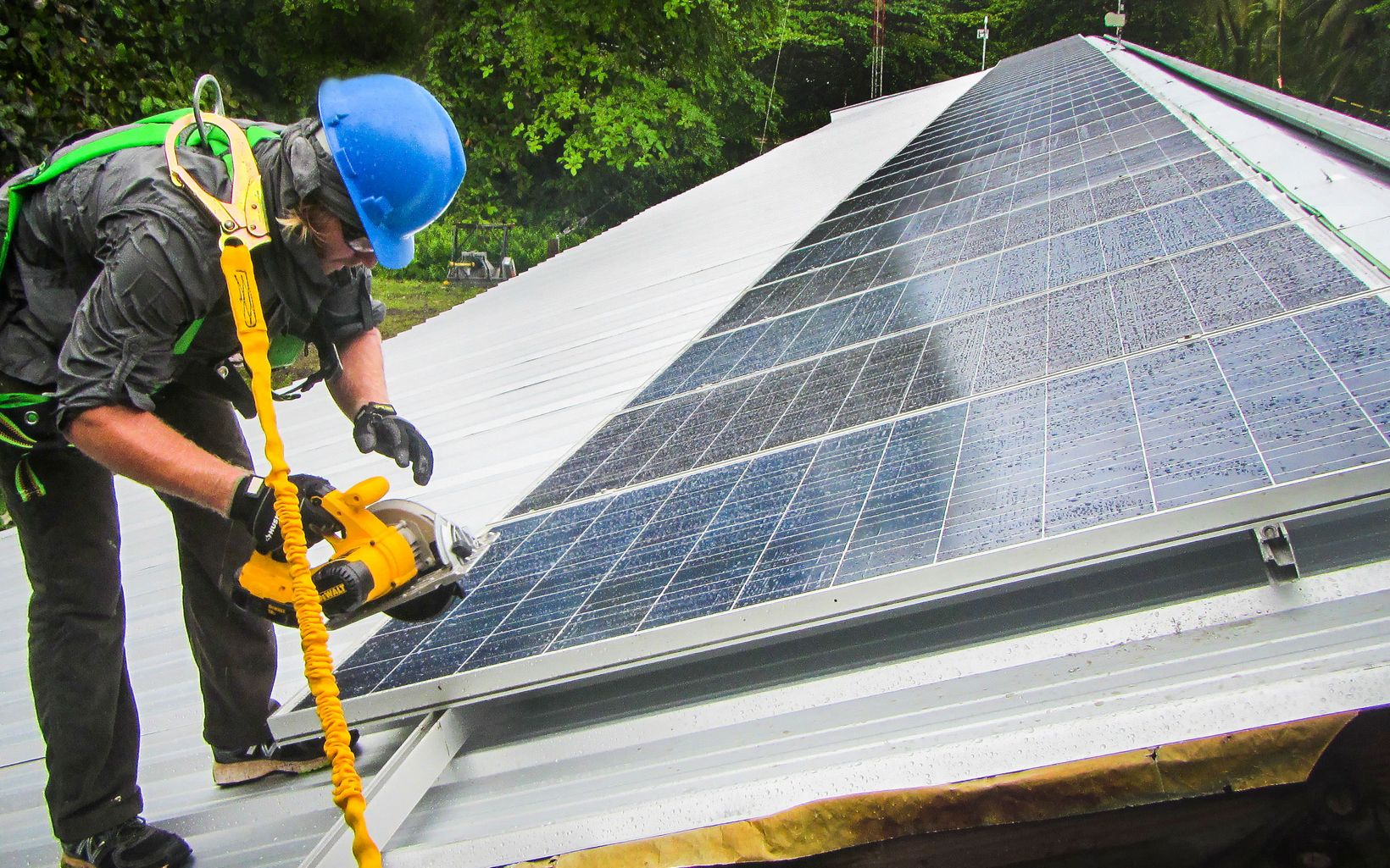 Volunteer installing rooftop solar panels