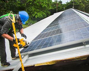 A worker installing a solar cell.