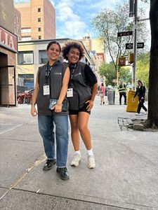 Two F2F canvassers smile while posing on a street in NY.