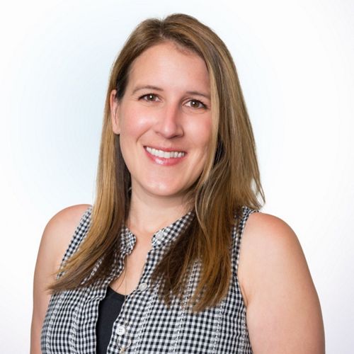 A woman with long brown hair poses for a head shot.