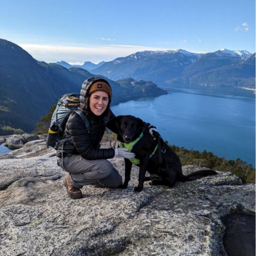 Person smiling with dog.