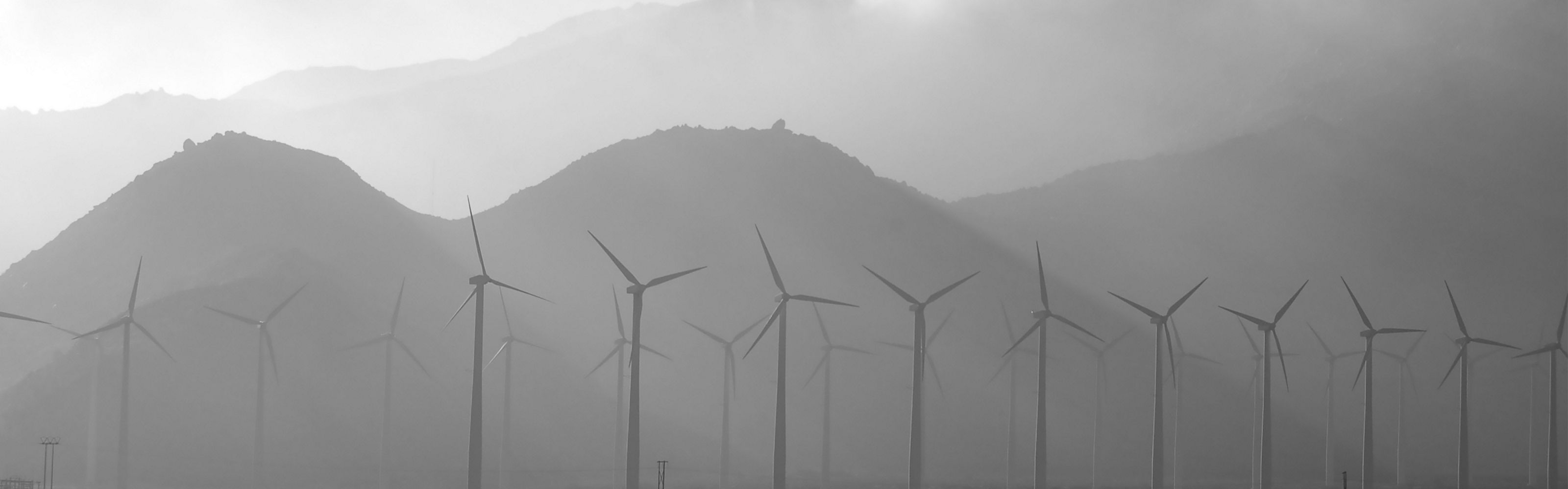 Wind turbines against a mountain backdrop