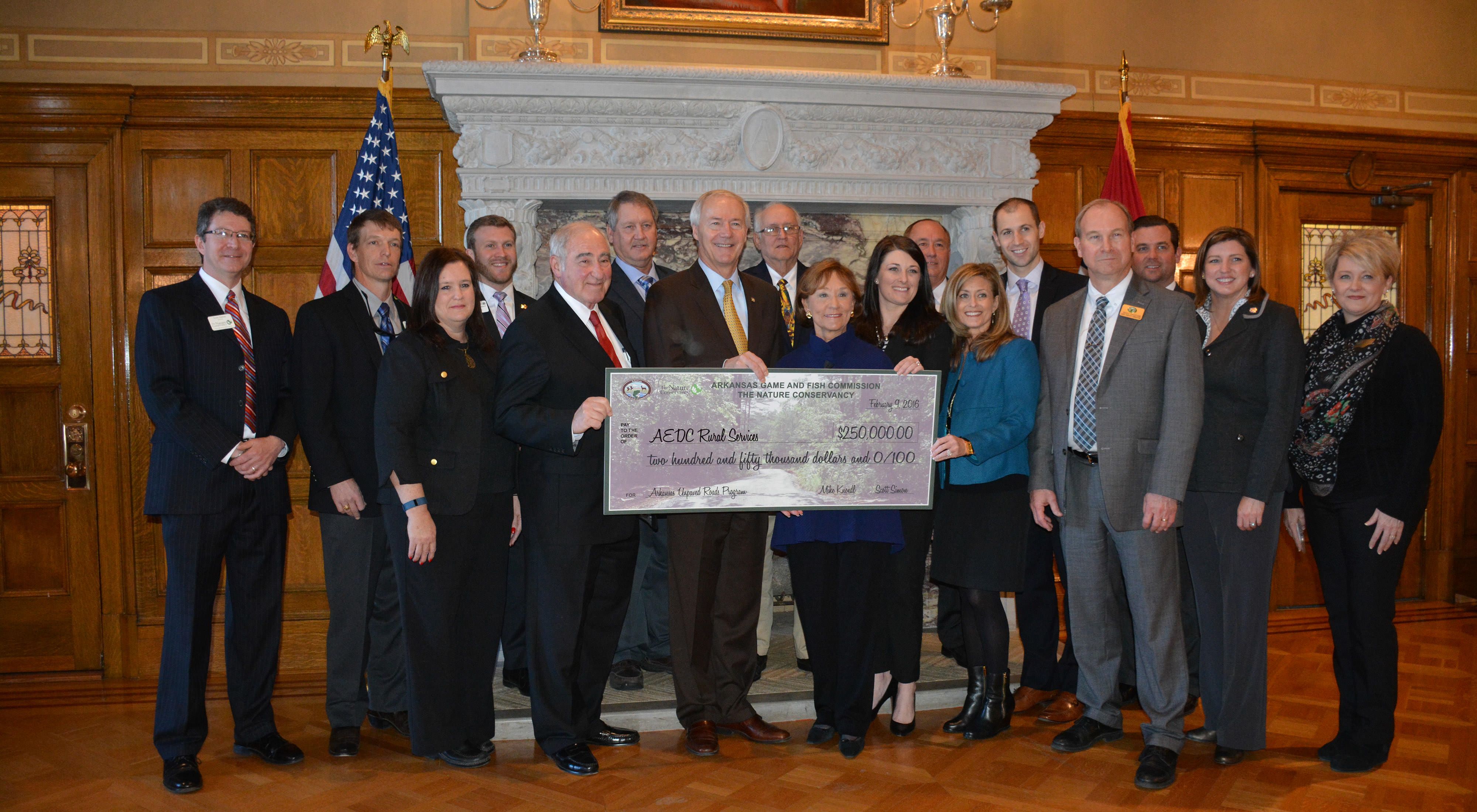 The Arkansas Game and Fish Commission and The Nature Conservancy present Governor Asa Hutchinson and the Department of Rural Services with a check to support the Unpaved Roads Program.