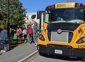 Students disembark from an electric bus on Mount Desert Island.