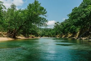 A calm blue creek on a clear day.