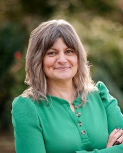 Headshot of Meg Connerton wearing a green blouse.