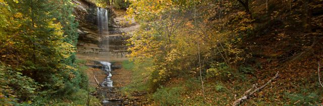 Image on the left of a waterfall rushing down a rock wall in a Michigan forest as the trees change color. On the right is the question: How much of U.S. drinking water originates from forests?
