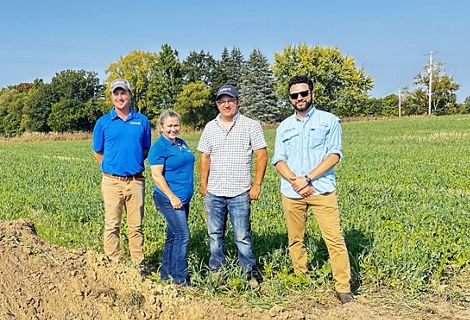 Ben Wickerham, Rebecca Hagerman, Jeff Bluemer and Simon Yevzelman of the TNC Soil Health team stand in a farm field.