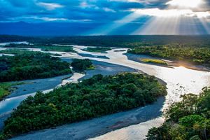 A flowing river in the Ecuadorian Amazon at sunset.