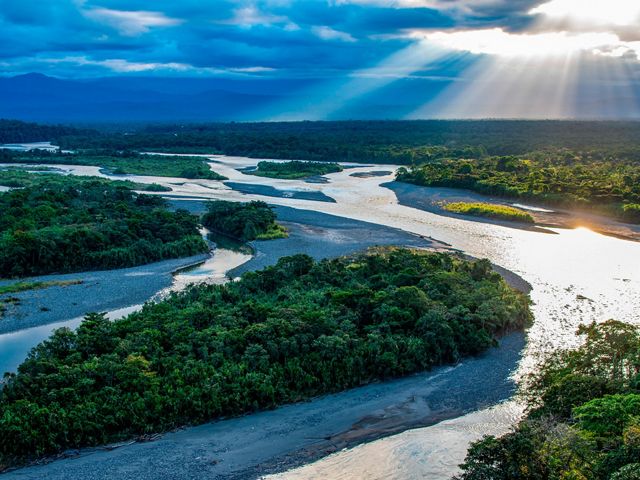 A flowing river in the Ecuadorian Amazon at sunset.
