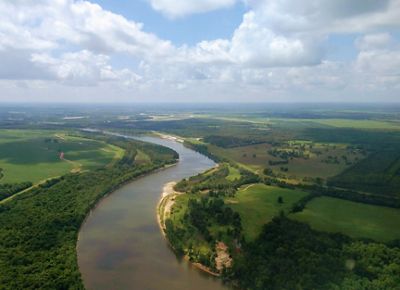 River running through farmland.