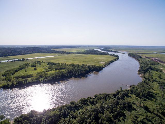 Aerial view of a winding river on a sunny day.