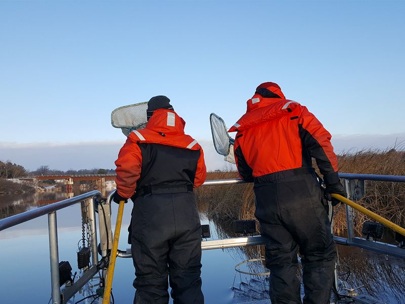 Gust Annis from TNC and Katherine Skubik from the Little Traverse Bay Bands of Odawa Indians, search for lake whitefish to net on a Michigan river.