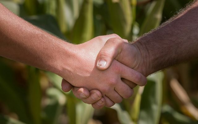 Saginaw Bay Watershed Agriculture, farmer and watershed  technician shake hands.