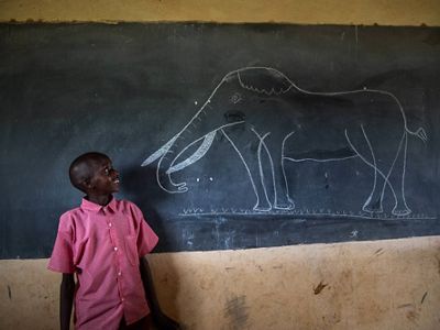 boy in front of chalkboard
