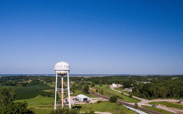 Aerial view over of a rural town and water tower.
