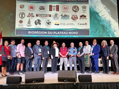 Group of people standing together on a stage.