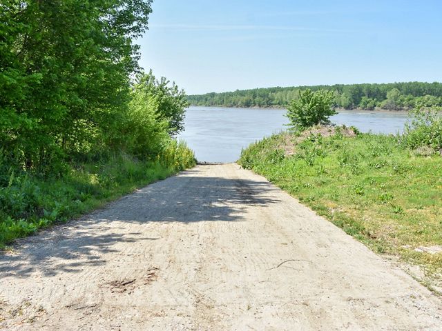 A paved boat ramp leading to the river.