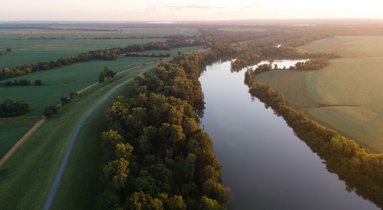 A river winds through forest and farmland.