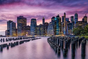 new york city manhattan skyline over east river with dock poles and bulkheads